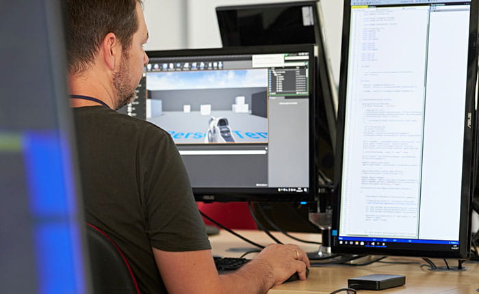 Person using two computer screens