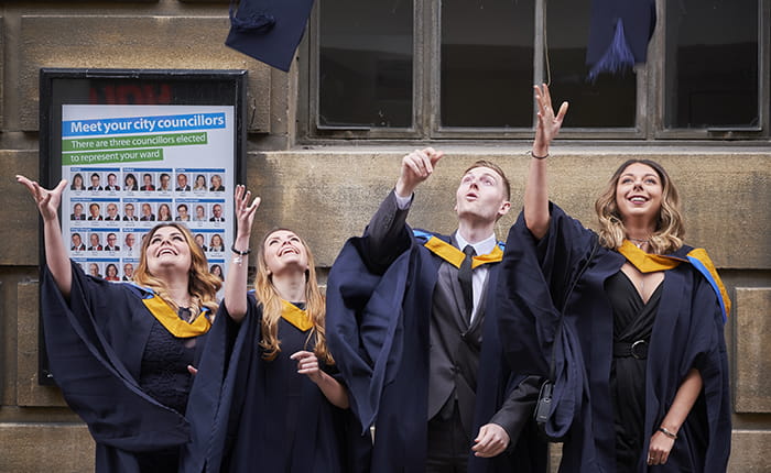 Graduating students throwing up their mortar boards