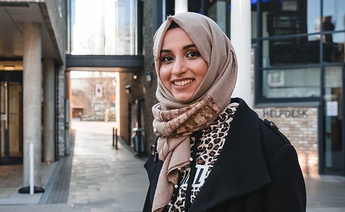 Social work student smiling and looking into the camera lense