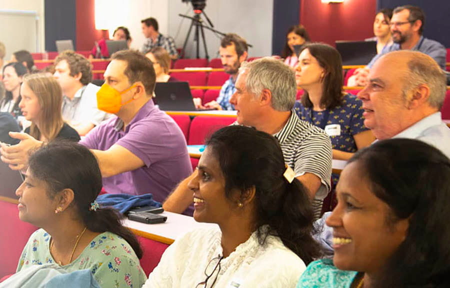 Smiling people sitting in a lecture theatre
