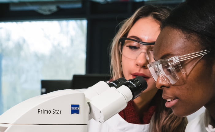 Students in Science Lab looking through Microscope