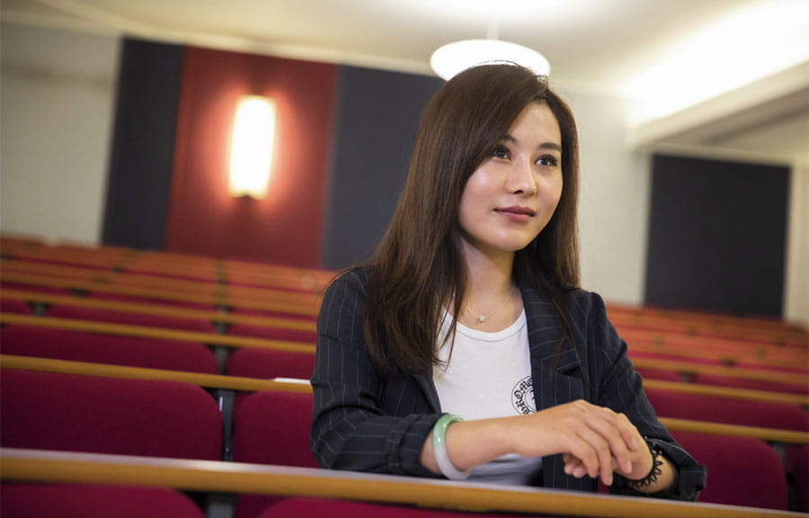 A student sitting in a lecture theatre