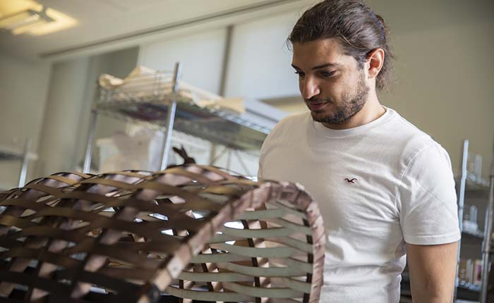 An Architecture student examining a model in the studio