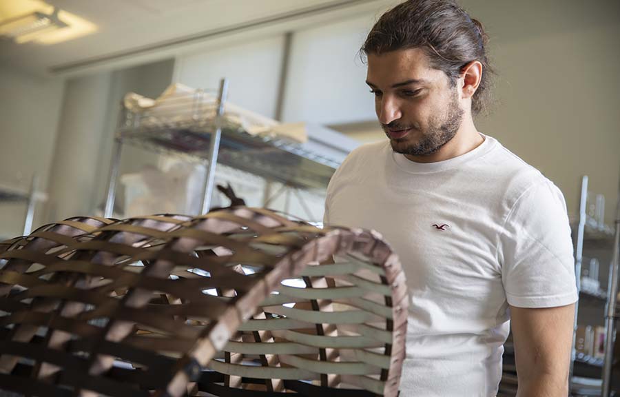An Architecture student examining a model in the studio