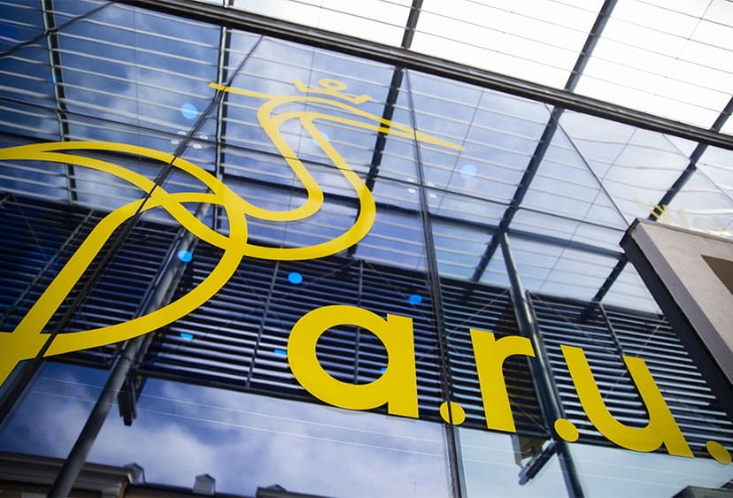 The Heron logo and "ARU" over the entrance to an ARU campus building