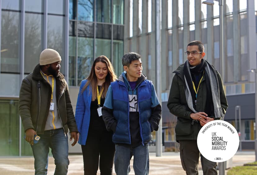 Four students walking on the ARU Peterborough campus