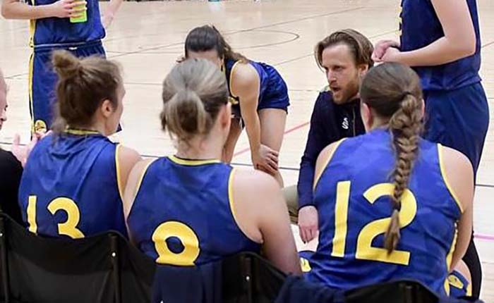 Members of the ARU women's basketball team with their coach