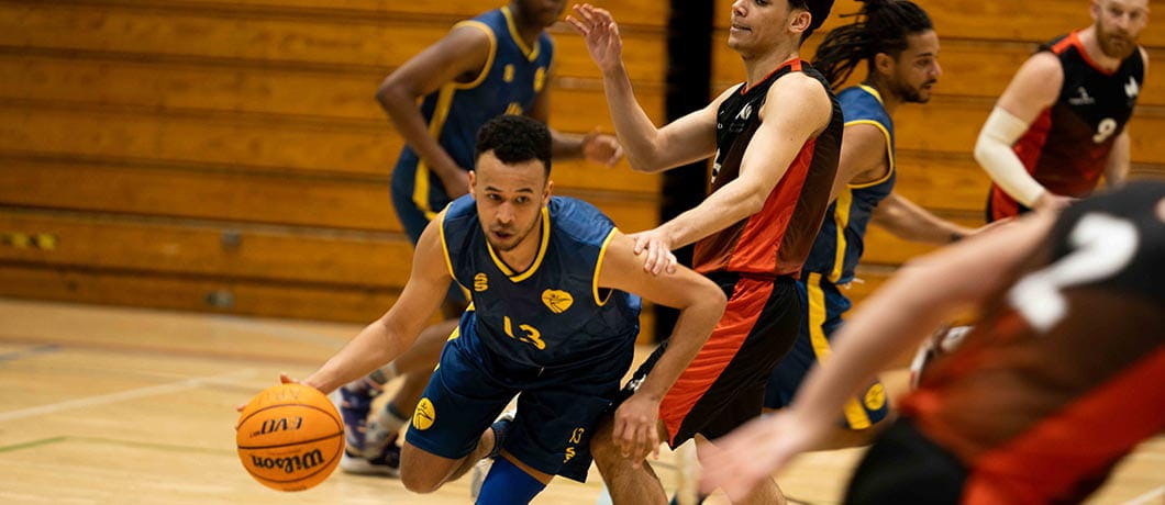ARU's Men's Basketball team running with basketball
