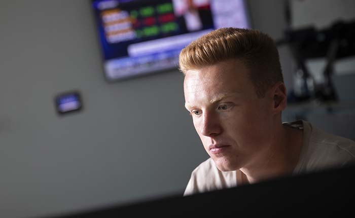 Person using computer in the Bloomberg Financial Markets Lab at ARU
