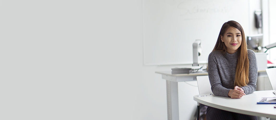 University student sitting at a desk in a classroom