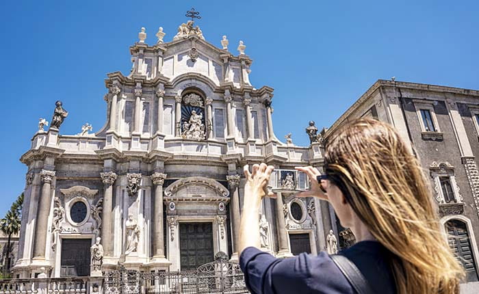 Person taking a photo of a basilica in Catania, Sicily
