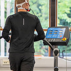 Back view of a person using a monitoring treadmill