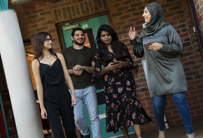 Four students outside accommodation at ARU's Chelmsford campus