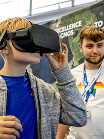 A child wearing a virtual reality headset at an exhibition stand