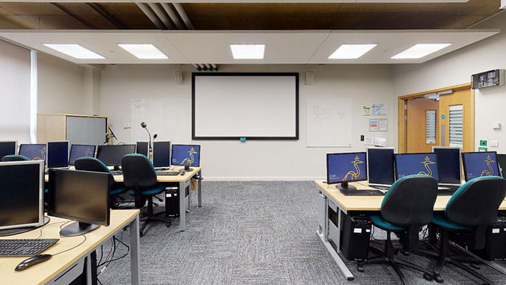 Desks and screens in a computer lab at Anglia Ruskin University
