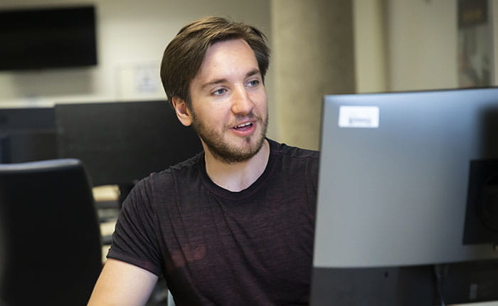 A male student working at a computer