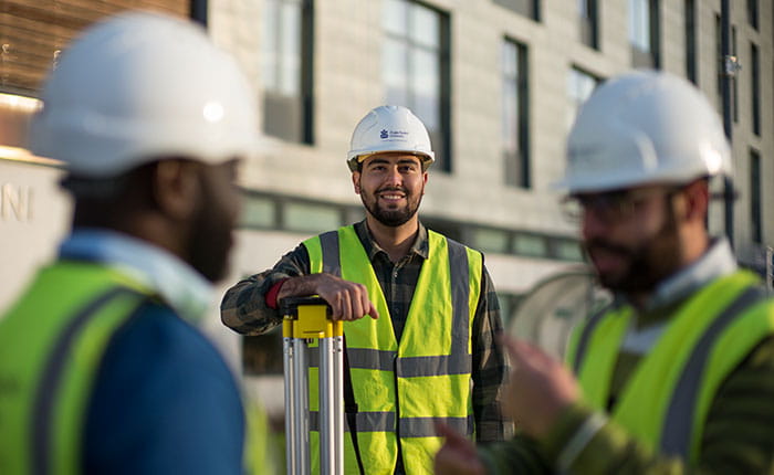 Students wearing hard hats and hi-vis jackets