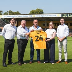 Representatives from ARU and CUFC holding a CUFC shirt