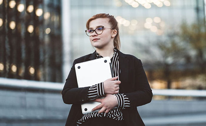 iStock image of Woman holding laptop