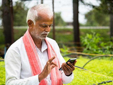 Farmer in India using a smartphone app