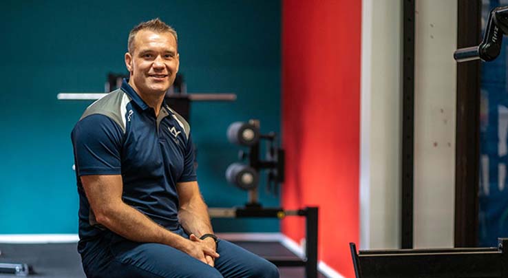 Mark Williams seated in a gym