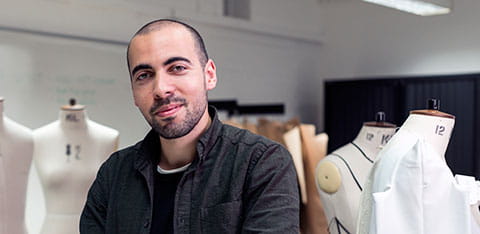 Fashion design student with mannequins