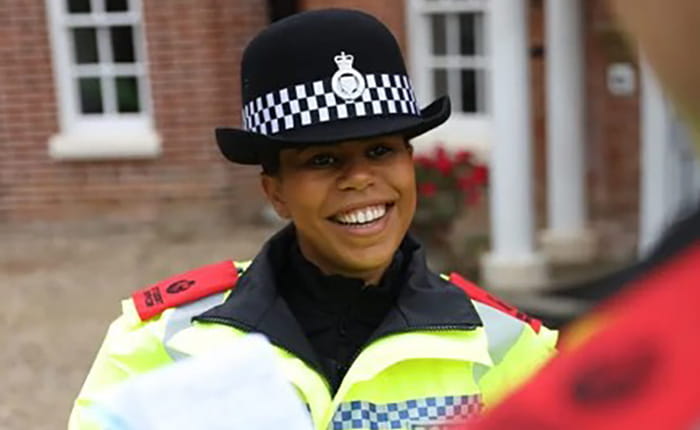 A female Police officer smiles to camera