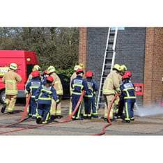 A group of young people training with firefighters as part of the Firebreak programme.