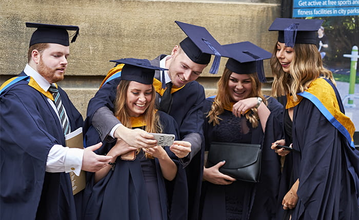 Graduates in Cambridge smiling 