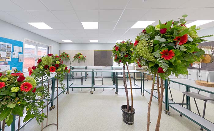 Floristry room with several freestanding floral designs on display