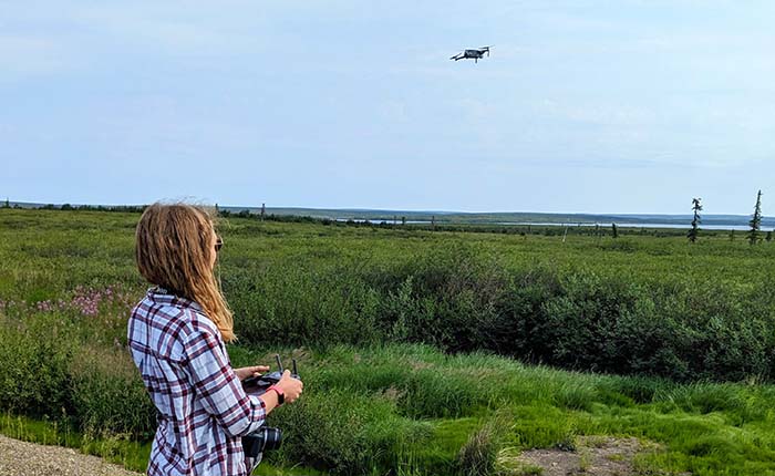 Researcher Georgia Hole carrying out a test flight with a drone