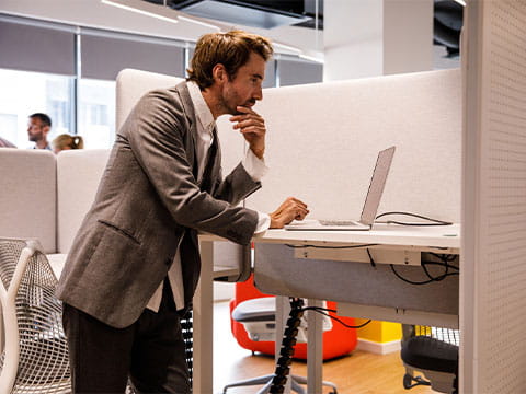 An office worker at a standing desk