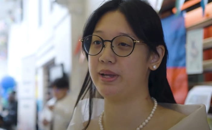 An female Asian student talks to camera in Cambridge campus