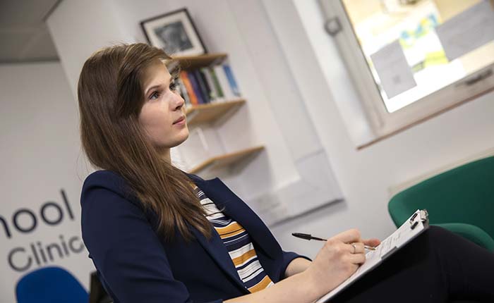 Anglia Ruskin University student taking notes in the Law Clinic