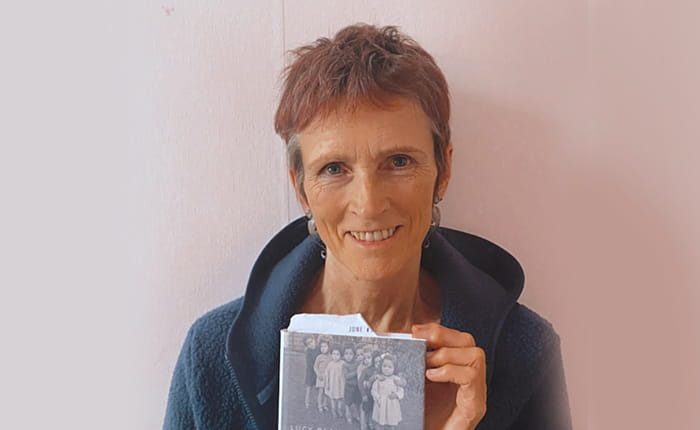 Lucy Bland holding a copy of her book Britain's Brown Babies