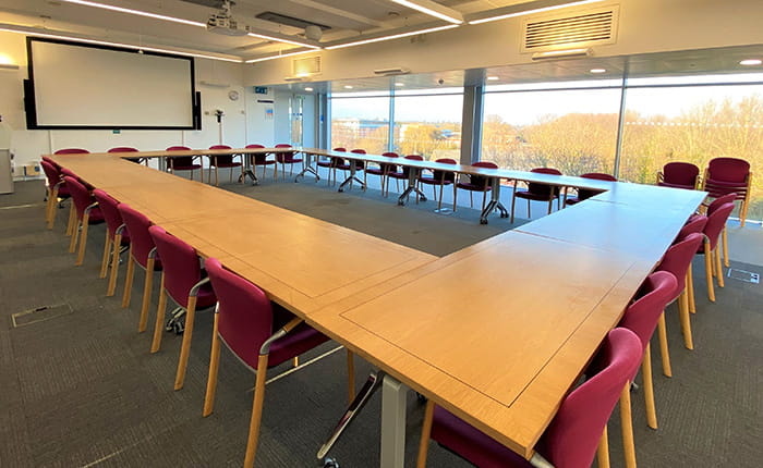 Tables and chairs arranged in 'boardroom' style