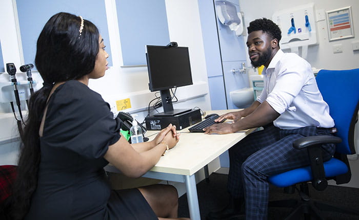 Two medical students in a consulting room