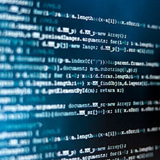 Close-up of blue and white code against a dark background