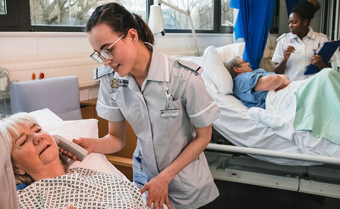 Nursing students treating patients on a ward