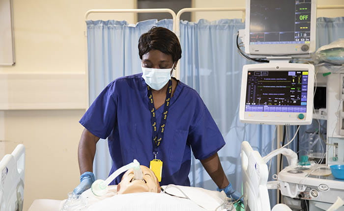 An ODP student practicing on a dummy in the skills lab