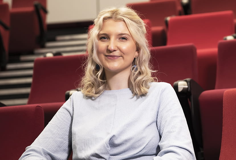 ARU student Olivia in a lecture theatre