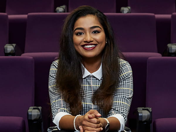 Female student sat in lecture theatre