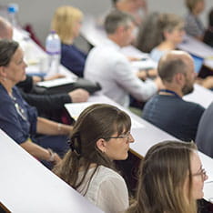 View of people sitting listening in a lecture theatre