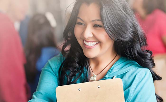 Person at a business event holding a clipboard