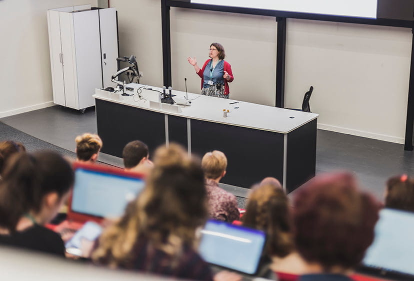 Suzannah Forwood addressing students in a lecture theatre