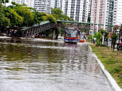 Bus driving along a flooded city street