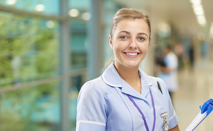 A nurse smiling at the camera