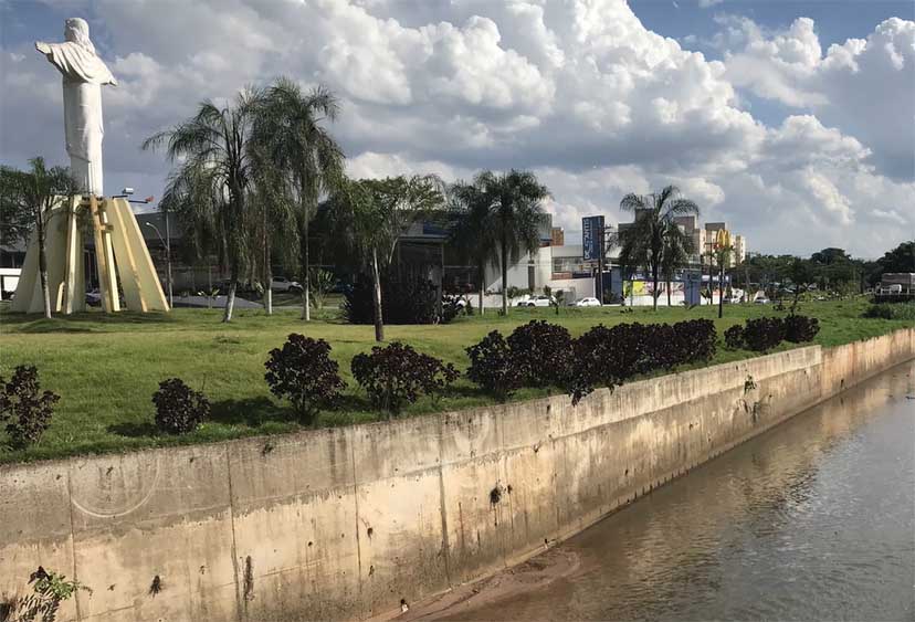 Video still of a river flowing past parkland in Brazil