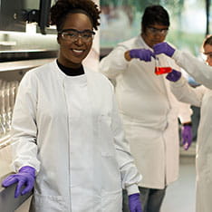 Three science students conducting experiments in a university lab