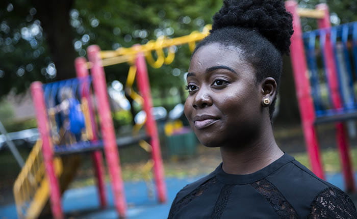 Headshot of a student standing by a playground